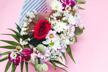 Box in the form of an envelope with a bouquet of flowers. Orchids, greenery, chrysanthemums and rose.