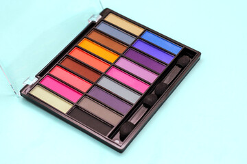 Multi-colored eye shadow palette. Bright colors and shades in cosmetics. Minimalism cosmetic concept.