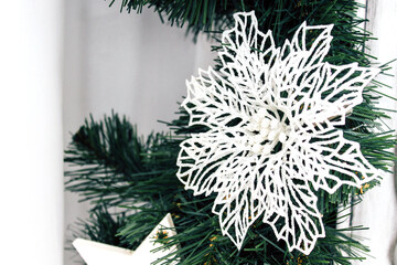 Christmas green tree decorated with white toys. Christmas flower decoration for fir branches