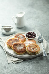 Traditional homemade cottage cheese cakes with berry sauce