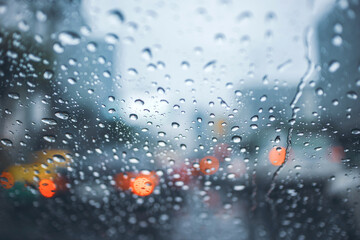 driving car on road in the rain with raindrop over the wind shield, traffic jam in rainy season