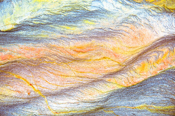 Rock layers - a colorful formations of sedimentary rocks stacked over the hundreds of years. Abstract background with fascinating texture for graphic design.