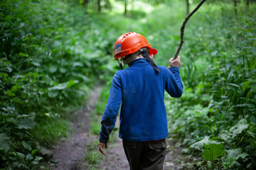 The child walks through the woods. The boy got lost in the woods. The preschooler ran away from home. 