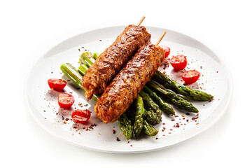 Fried meat with asparagus on white background

