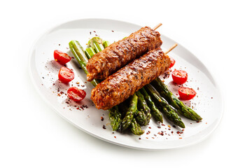 Fried meat with asparagus on white background

