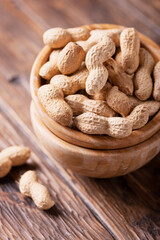  Roasted peanuts in wooden bowl