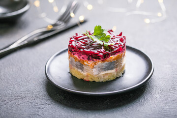 Shuba salad. Russian layered salad with beet, potato, carrot,  pickled herring and mayonnaise for Christmas dinner