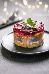 Shuba salad. Russian layered salad with beet, potato, carrot,  pickled herring and mayonnaise for Christmas dinner