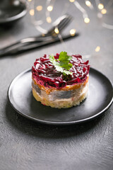 Shuba salad. Russian layered salad with beet, potato, carrot,  pickled herring and mayonnaise for Christmas dinner