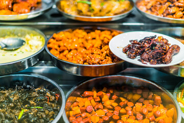 Traditional Asian dishes sold in a food court in Singapore