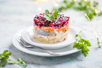Shuba salad. Russian layered salad with beet, potato, carrot,  pickled herring and mayonnaise for Christmas dinner