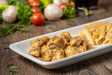 grilled cubed chicken with pasta and salad