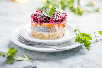 Shuba salad. Russian layered salad with beet, potato, carrot,  pickled herring and mayonnaise for Christmas dinner