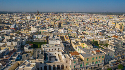 Fototapeta na wymiar Beautiful panoramic aerial view photo from flying drone on Molfetta waterfront and the old town from a great height.Port with ships and yachtsand the Molfetta new city at sunrise.Apulia,Italy (Series)