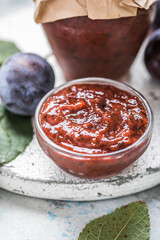  Georgian tkemali sauce with ingredients on rustic table.