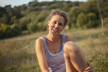 Stylish positive beautiful young woman laughing at picnic. Great design for any purposes. Young happy cheerful brunette model.