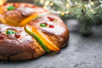 Rosca de reyes, spanish three kings cake eaten on epiphany day, on a gray rustic table