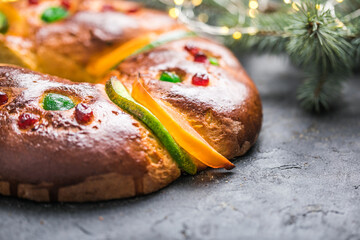 Rosca de reyes, spanish three kings cake eaten on epiphany day, on a gray rustic table
