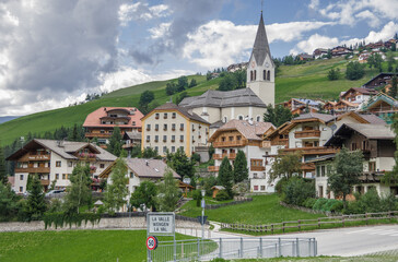 Fototapeta na wymiar La Val village and its surrounding churches, Alta Badia, Dolomites, South Tirol, Italy.