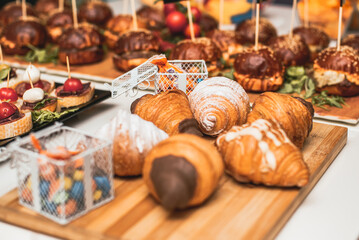 Delicious croissants on decorative table for party