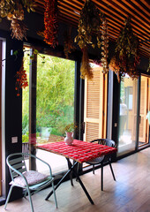 Table and chairs on the terrace overlooking the garden. Cozy interior.
