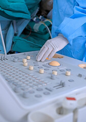 Cardiologist holding transesophageal ultrasound probe and use echocardiogram to assessment...
