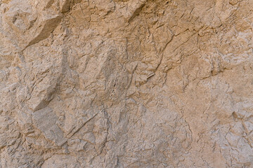 Obraz na płótnie Canvas uneven surface brown rock wall,