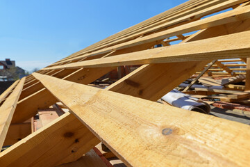 wooden rafters on the roof of the house under construction