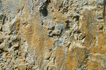 stone surface with yellow, gray and blue spots