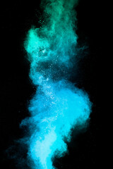 Launched blue dust particles splashing.Bizarre forms of blue powder explosion cloud on white...