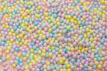 Purple, yellow, blue plastic balls.