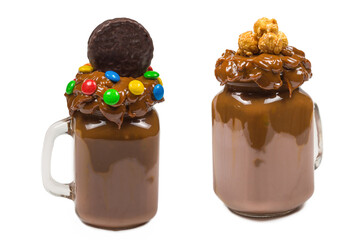 Chocolate milkshake with whipped cream, cookies, waffles, served in glass mason jar. 