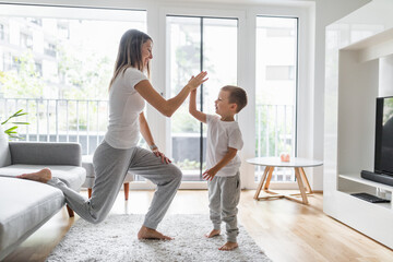 Mom with her son working out in the living room