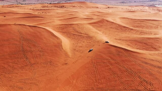 Aerial view of the off road car driving through Red Sand Dunes in Riyadh, Saudi Arabia 4k #7