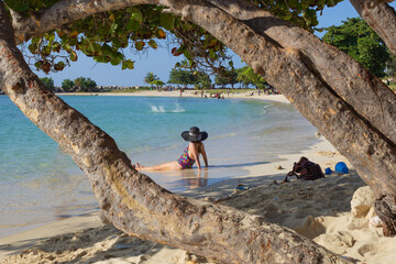 Women sitting on the sand watching the sea.