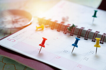close up of calendar and pin on the map, travel planning concept