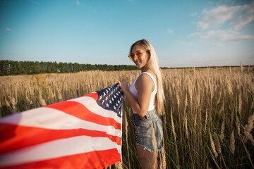 beautiful young female in sunglasses with american flag