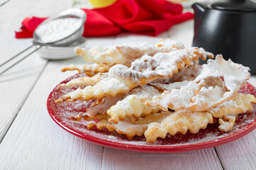 Brushwood - crispy deep fried cookies in powdered sugar with tea and jam. A traditional treat at European festivals.