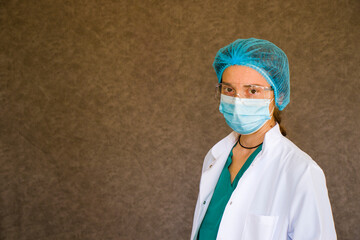 Woman doctors portrait, doctors with mask, glasses, glove and uniform.