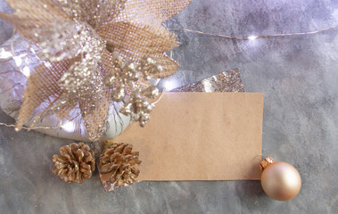 beautiful New Year's decor in silver-gold tones, unusual flower, pine cones, blank card, stylish...