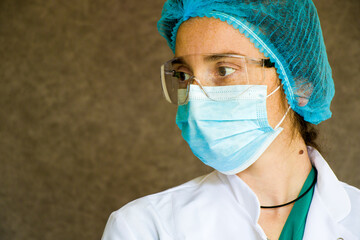 Woman doctors portrait, doctors with mask, glasses, glove and uniform.