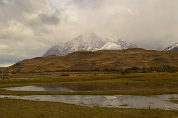 Hiking around the dramatic and windy mountain landscapes of Torres del Paine in Patagonia, Chile