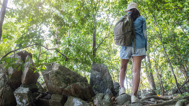 Hipster Asian woman hiking in mountain, wild adventure. Adventure Travel Concept.
