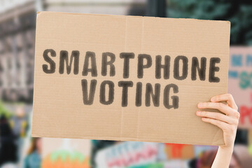 The phrase " Smartphone Voting " on a banner in men's hand with blurred background. Presidential election. Politics. Power. Technology. Government. Security. Voter