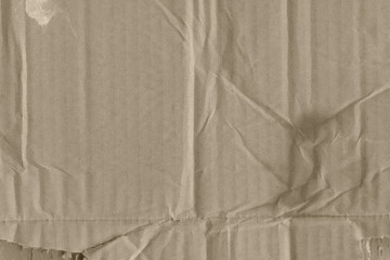 Close up of a light brown vintage rough sheet of carton. Cardboard paper texture with a blank background. Empty papercraft surface. Recycled environmentally friendly material.