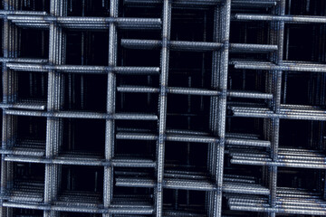 Steel mesh for construction Steel Rebars for reinforced concrete. Steel reinforcement bar texture in construction site.