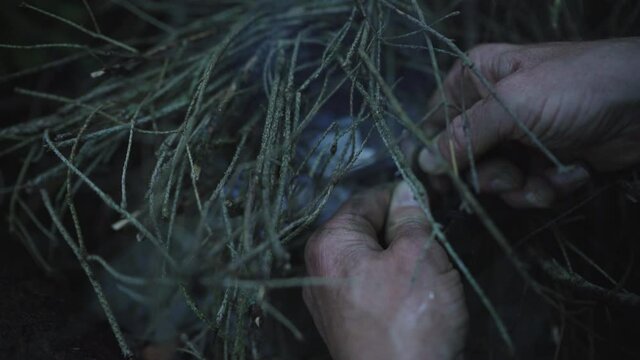 4K close up footage of person trying start up fire with flintstone. Cave people concept, survival guide concept.
