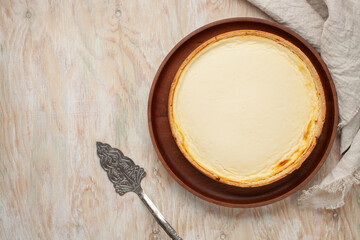 Cheesecake New York  on a plate on a wooden background. Top view