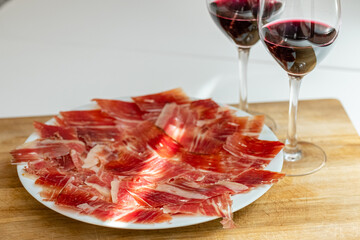 Plate of Iberian ham and glasses of Spanish red wine