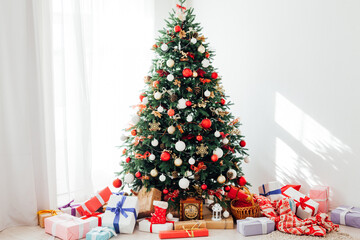 Christmas tree by the window with gift decor for the new year interior of the holiday house